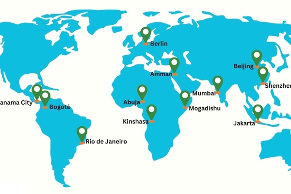 A world map highlights eleven cities: Panama City, Bogotá, Rio de Janeiro, Abuja, Kinshasa, Berlin, Amman, Mumbai, Mogadishu, Beijing, Jakarta, and Shenzhen. Green location markers indicate each city on the light blue map.